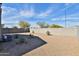 Large gravel backyard with desert landscaping and block fence at 30968 W Monterey Ave, Buckeye, AZ 85396