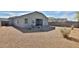 Backyard featuring desert landscaping, gravel, and a view of the home's exterior at 30968 W Monterey Ave, Buckeye, AZ 85396