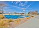 Outdoor basketball court featuring blue pavement, lush green landscape and abundant lighting at 30968 W Monterey Ave, Buckeye, AZ 85396