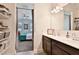 Bathroom leading to bedroom features a spacious vanity with double sinks and view into bedroom at 30968 W Monterey Ave, Buckeye, AZ 85396