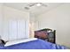 Bedroom featuring a crib, a closet, and neutral tones at 30968 W Monterey Ave, Buckeye, AZ 85396