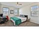 Well-lit bedroom with a ceiling fan, carpeted floors, and a neatly made bed with neutral bedding at 30968 W Monterey Ave, Buckeye, AZ 85396