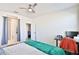 Bedroom featuring a ceiling fan, bed with a teal blanket, and a view of the closet at 30968 W Monterey Ave, Buckeye, AZ 85396