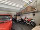 Garage interior with overhead storage racks and parked vehicles at 30968 W Monterey Ave, Buckeye, AZ 85396