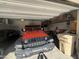 Spacious garage with overhead storage racks and vehicles at 30968 W Monterey Ave, Buckeye, AZ 85396