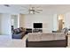 Comfortable living room featuring tile floors, a ceiling fan, and ample seating space at 30968 W Monterey Ave, Buckeye, AZ 85396