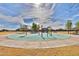 Brightly colored splash pad area with a circular design, seating, and open space for to enjoy at 30968 W Monterey Ave, Buckeye, AZ 85396