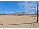 Sand volleyball court with nets and ample space for play, set against a clear blue sky at 30968 W Monterey Ave, Buckeye, AZ 85396