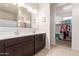 Double vanity bathroom with a walk-in closet at 31045 W Cheery Lynn Rd, Buckeye, AZ 85396