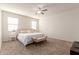 Large bedroom with a king-size bed and bench at 31045 W Cheery Lynn Rd, Buckeye, AZ 85396