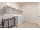 Laundry room with washer, dryer and shelving at 31045 W Cheery Lynn Rd, Buckeye, AZ 85396