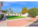 Landscaped backyard with artificial turf, a brick patio, and a built in fire pit creates a beautiful outdoor space at 3352 E Hopi Ave, Mesa, AZ 85204