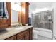 Bathroom features a vanity with a granite countertop and a shower over tub at 3352 E Hopi Ave, Mesa, AZ 85204