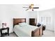 Cozy bedroom featuring a dark wood dresser, ceiling fan, and a window with shutters that fill the space with natural light at 3352 E Hopi Ave, Mesa, AZ 85204