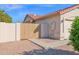 Well-maintained exterior with a wood gate and a two-car garage offering security and convenience at 3352 E Hopi Ave, Mesa, AZ 85204