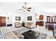 Bright living room boasts an open floor plan, neutral tones, stylish ceiling fan, and a seamless flow into the dining area at 3352 E Hopi Ave, Mesa, AZ 85204