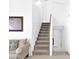 Inviting staircase with carpeted steps, wooden handrail, and neutral decor, leading to the upper level of the home at 3352 E Hopi Ave, Mesa, AZ 85204