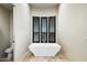 Luxurious bathroom featuring a freestanding tub and plantation shutters at 36430 N 34Th Ave, Phoenix, AZ 85086