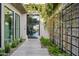 Elegant entryway with a courtyard, lush landscaping, and modern door at 3990 E Alameda Ln, Gilbert, AZ 85298