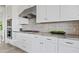 White kitchen with gray tile backsplash and stainless steel appliances at 3990 E Alameda Ln, Gilbert, AZ 85298