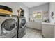 Modern laundry room with washer, dryer, and ample counter space at 3990 E Alameda Ln, Gilbert, AZ 85298