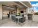 Outdoor kitchen with built-in grill and bar seating area at 3990 E Alameda Ln, Gilbert, AZ 85298