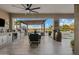 Outdoor kitchen and dining area with pergola and pool view at 3990 E Alameda Ln, Gilbert, AZ 85298