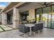 Covered patio with outdoor dining set and adjacent to the pool at 3990 E Alameda Ln, Gilbert, AZ 85298