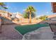 Landscaped backyard with putting green and palm tree at 4248 E Raven Rd, Phoenix, AZ 85044