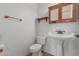 Small bathroom with pedestal sink and wood cabinet at 4248 E Raven Rd, Phoenix, AZ 85044