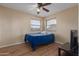 Bright bedroom with wood floors, a ceiling fan, and window blinds at 4248 E Raven Rd, Phoenix, AZ 85044