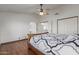 Main bedroom with wood floors, ceiling fan and en-suite bathroom at 4248 E Raven Rd, Phoenix, AZ 85044