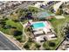 Aerial view of the community pool and tennis courts surrounded by green spaces and well-maintained landscaping at 4248 E Raven Rd, Phoenix, AZ 85044