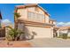 Two-story house with a tan exterior, two-car garage, and landscaped front yard at 4248 E Raven Rd, Phoenix, AZ 85044