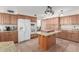 Kitchen with island, granite counters, and wood cabinets at 4248 E Raven Rd, Phoenix, AZ 85044