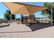 playground with slides covered by a shade canopy for sun protection at 4248 E Raven Rd, Phoenix, AZ 85044