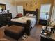 Relaxing bedroom featuring a decorative headboard, matching dresser, and soft, warm colors at 43726 W Carey Dr, Maricopa, AZ 85138