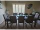 Dining room with wooden table, six chairs and modern decoration with carpets at 43726 W Carey Dr, Maricopa, AZ 85138