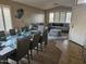 Open concept living room and dining area with tile floors, neutral paint, and gray couch at 43726 W Carey Dr, Maricopa, AZ 85138