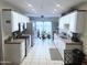 Bright kitchen featuring white cabinets, stainless appliances, and sliding glass doors to outdoor patio at 455 S Delaware Dr # 117, Apache Junction, AZ 85120