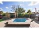 Inviting backyard oasis featuring a sparkling pool and spacious patio area at 5013 W Orchid Ln, Glendale, AZ 85302