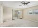 Spacious bedroom with mirrored closet doors and ceiling fan at 5013 W Orchid Ln, Glendale, AZ 85302