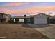 Updated single-story home with a two-car garage and well-maintained lawn at 5013 W Orchid Ln, Glendale, AZ 85302