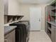 Laundry room with washer, dryer, and cabinets at 5013 W Orchid Ln, Glendale, AZ 85302