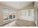 Bright living room with built-in shelving and hardwood floors at 5013 W Orchid Ln, Glendale, AZ 85302