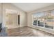 Living room featuring hardwood floors and a view of the front yard at 5013 W Orchid Ln, Glendale, AZ 85302