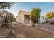 The well-maintained backyard features desert landscaping, a stone fire pit, and a covered patio at 505 W Wayland Dr, Phoenix, AZ 85041