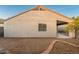 Backyard featuring gravel ground cover and stucco exterior with small window at 505 W Wayland Dr, Phoenix, AZ 85041