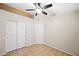 Bedroom featuring neutral walls, tile floors, ceiling fan, and closet at 505 W Wayland Dr, Phoenix, AZ 85041