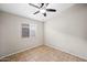 Cozy bedroom featuring neutral walls, tile floors, and a ceiling fan at 505 W Wayland Dr, Phoenix, AZ 85041